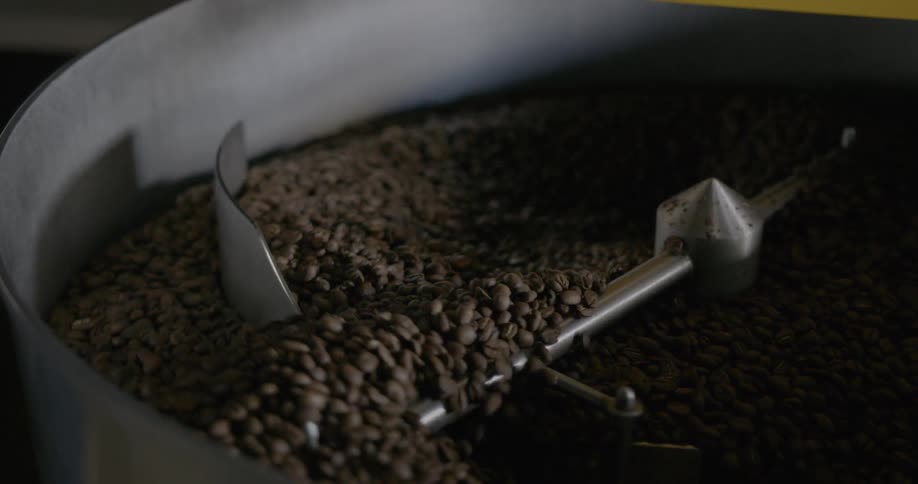 A large machine turns beans