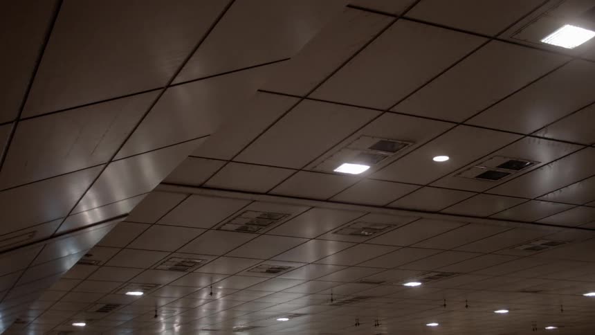 Lights shine on a ceiling at night