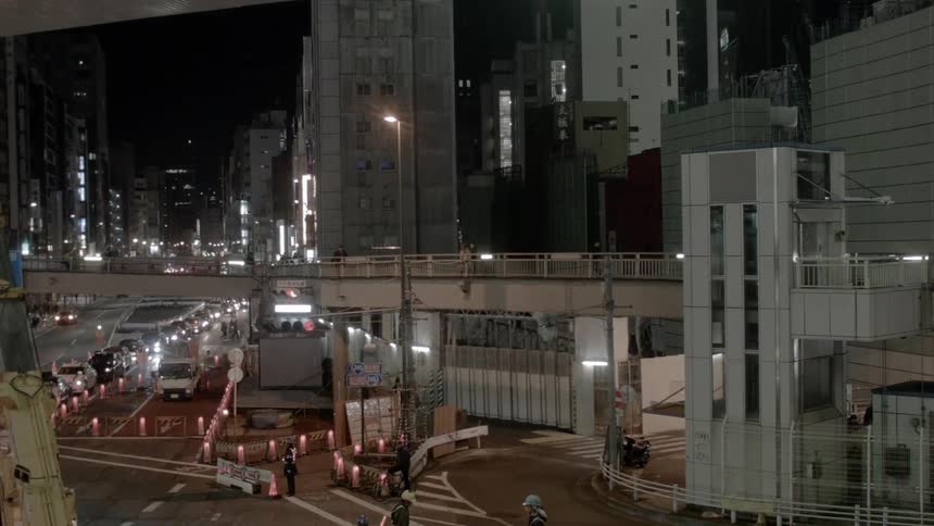 A crane and construction block travel on a city street