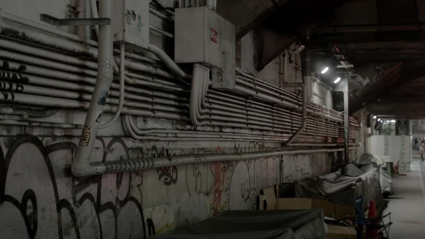 People walk in the distance of the long hall