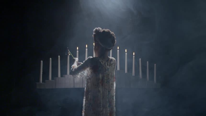 A child is putting out candles in a row