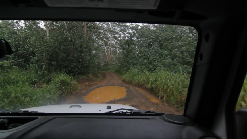 A car is driving down the road