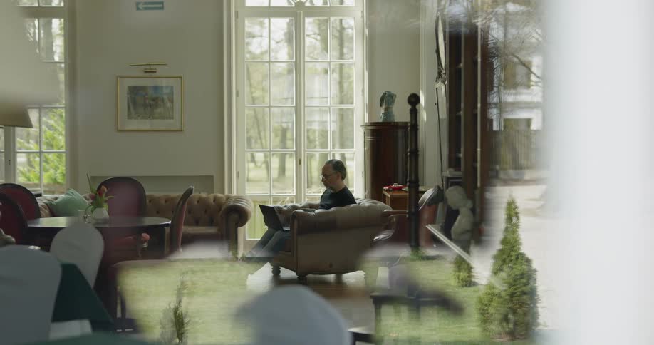 A man is sitting in a living room