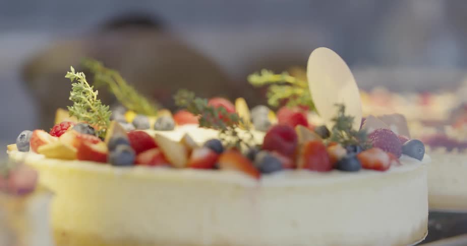 A cheesecake topped with multiple fruits
