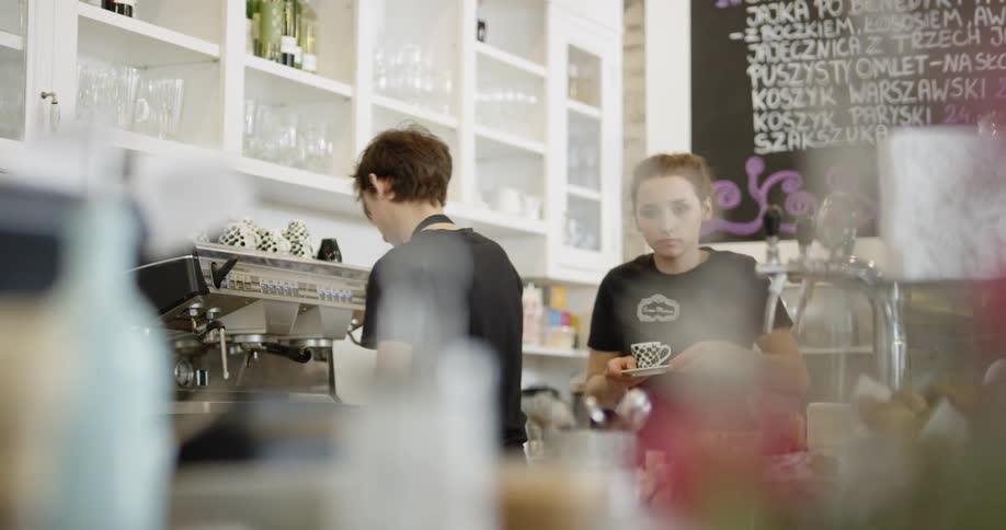 Baristas making coffee in a cafe