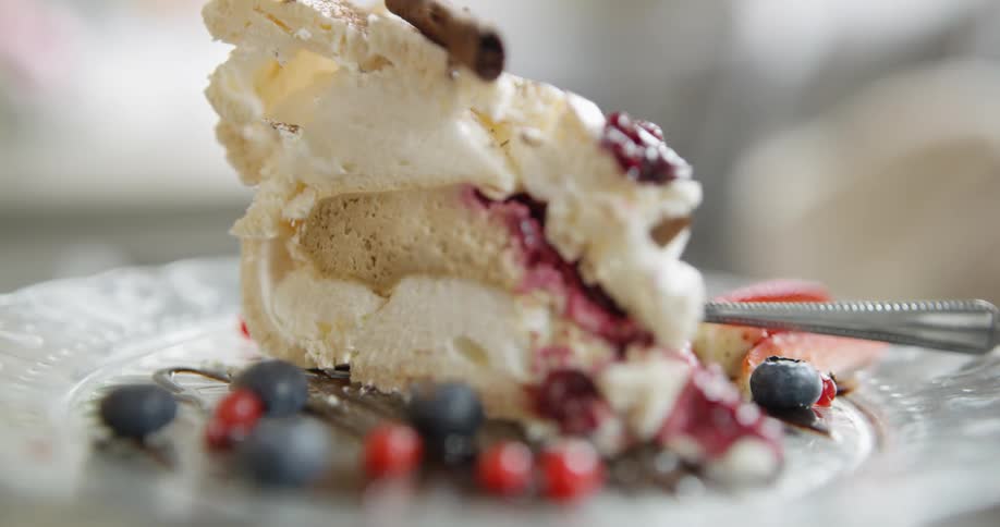 A plated dessert with berries and meringue
