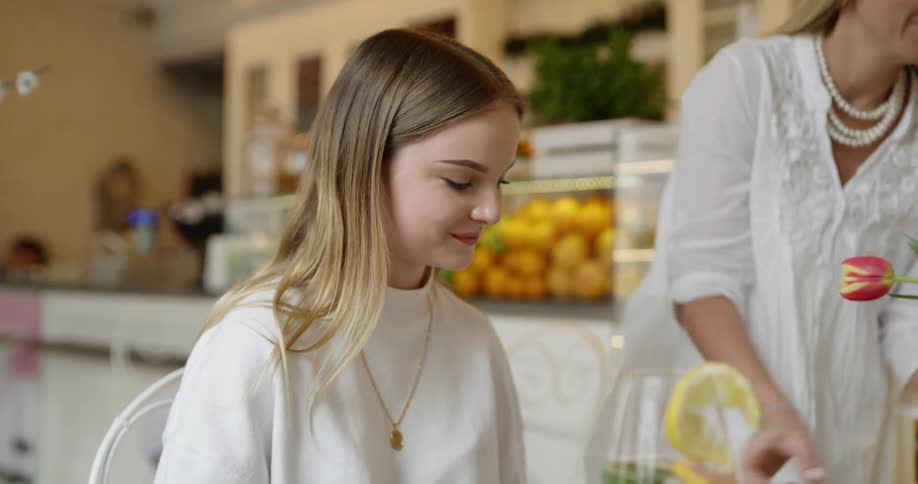 A girl is served a dinner at a table in a restaurant