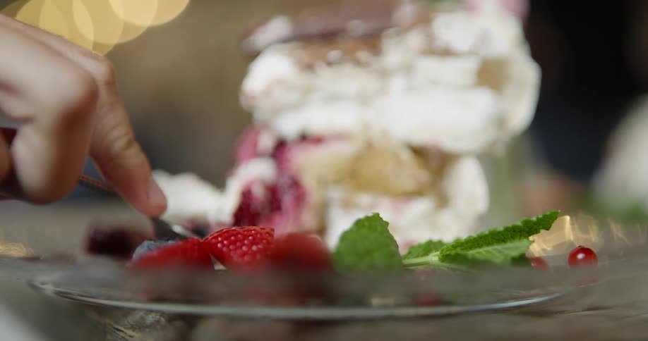 A person eats a piece of fruit and cream pie