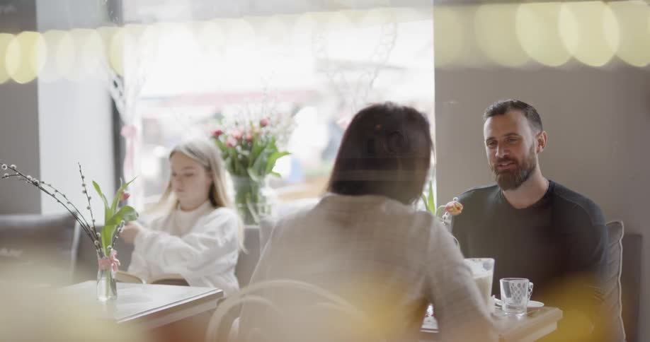 Several people at tables in a cafe