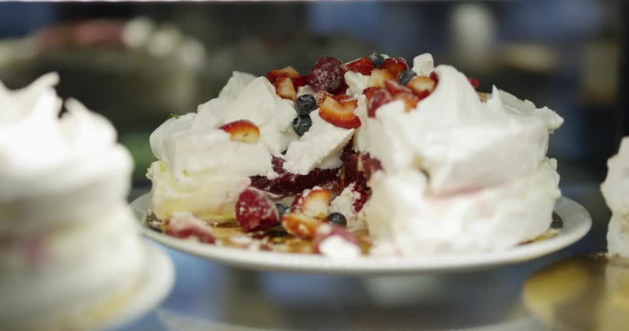 A cake with blueberries and strawberries