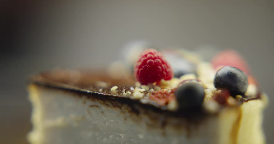A cheesecake with blackberry and raspberry on top