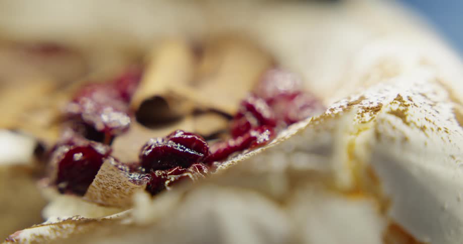 Berries and chocolate shavings cover a creamy dessert