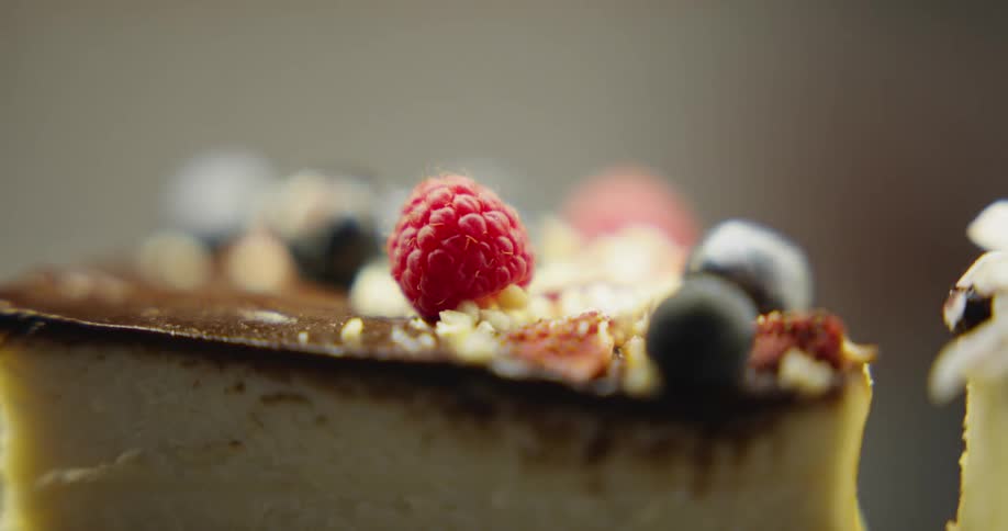 A cheesecake with raspberry and blackberry on top