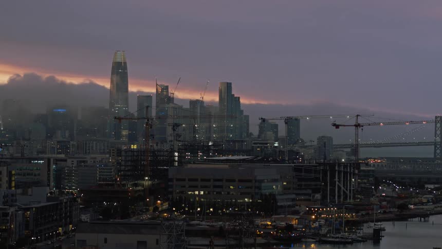 An aerial view of a downtown skyline is displayed