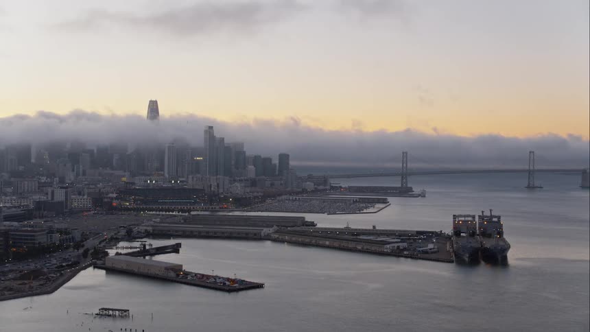 Thick fog sits on top of a lakeside city