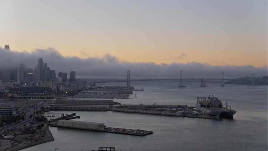 Skyline view of a city water and piers on a foggy day