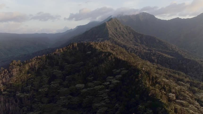 An aerial view of a mountain peak in the wild