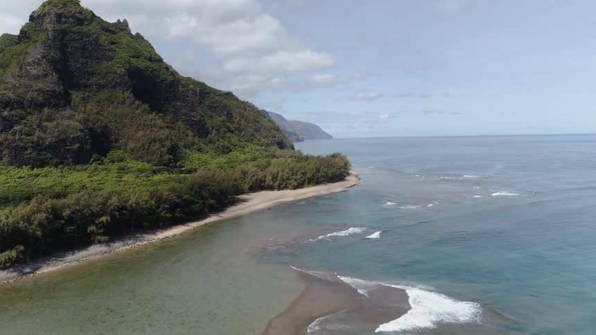 A bird eye view of a beautiful island with mountain and blue ocean