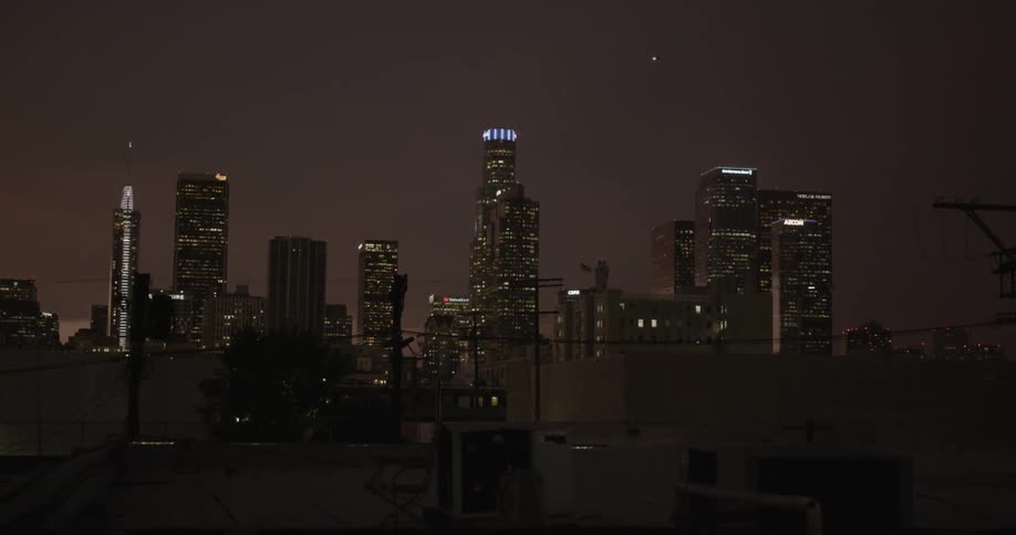 A night view of a city skyline from the neighborhood