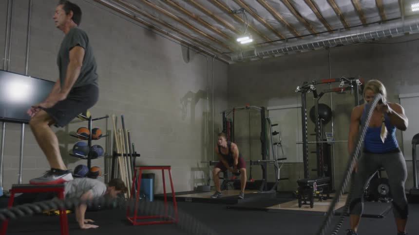 People exercise together in a gym with equipment