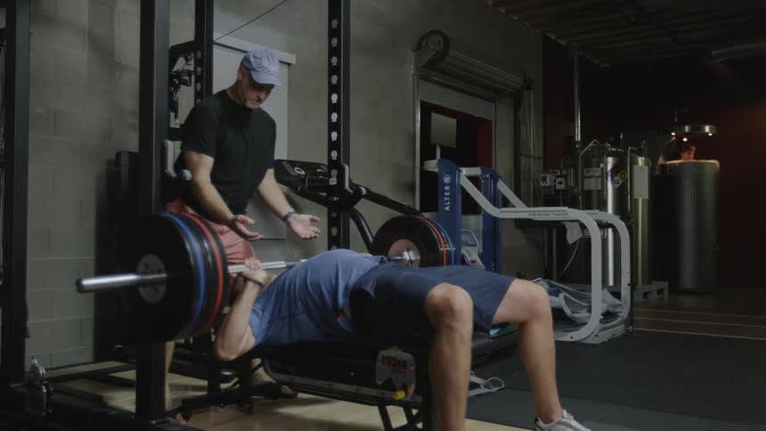 Man working out at the gym using weight lifting