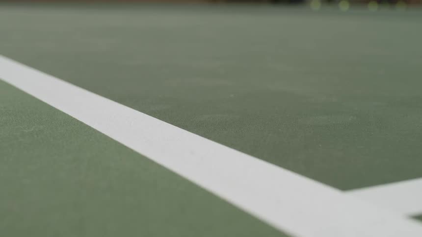 A tennis ball bounces just within the line