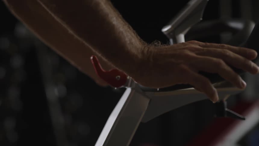 A man is riding a stationary bicycle