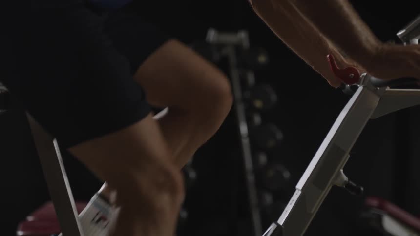Man exercising with static bike on the gym
