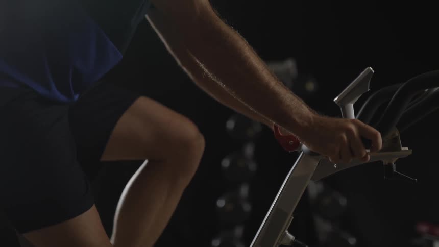 A person rides an exercise bike