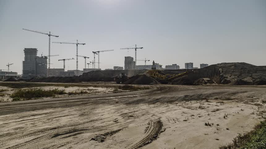 Construction trucks and equipment working on a construction site in the city