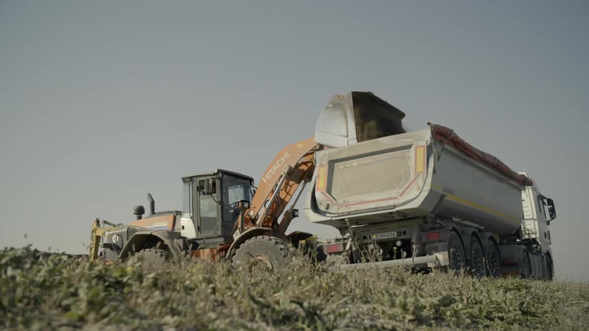 A bulldozer fill truck with sands