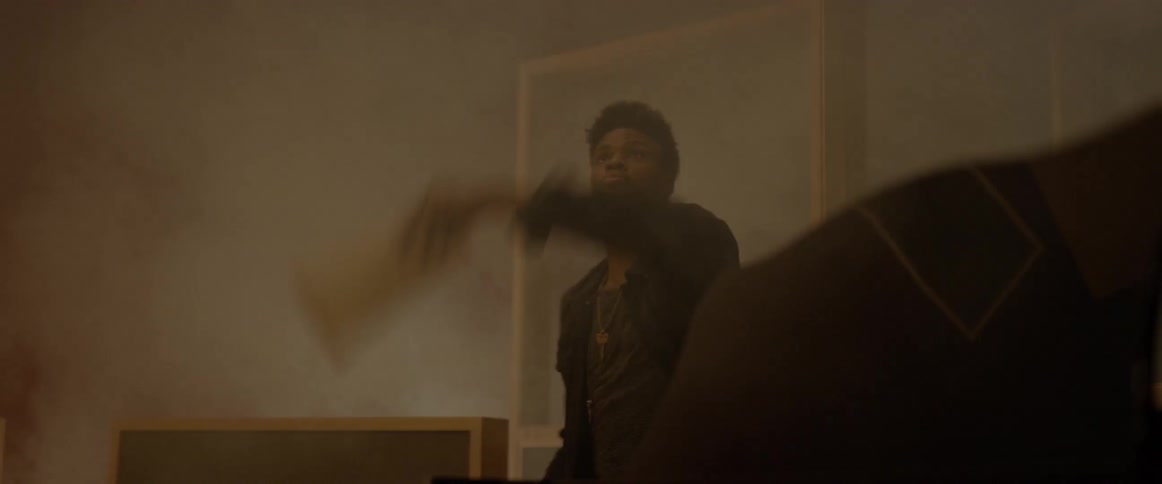 Black man trying to eliminate the smoke in the room