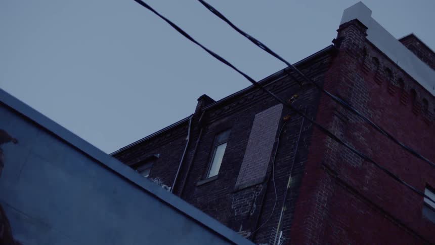 A power line runs in front of buildings in a city