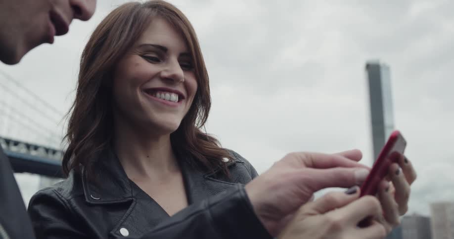 A woman and man take a selfie together with a smart phone