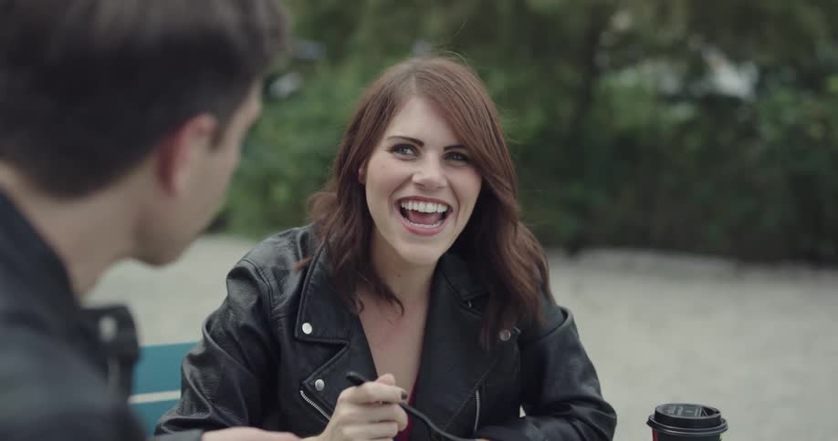 A young woman sits and talks with a man