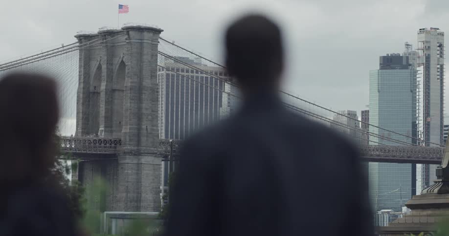 Tourists taking pictures of the brooklyn bridge with their cellphones