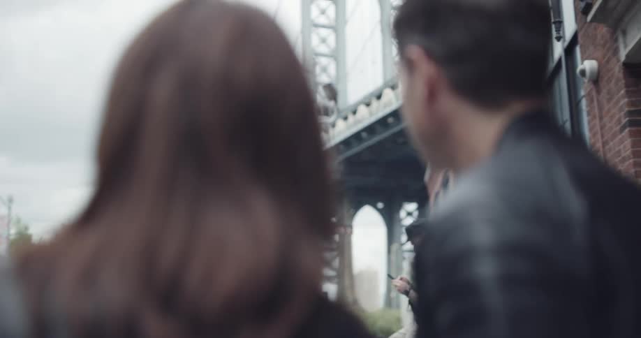 Couple sightseeing in a city and admiring a bridge