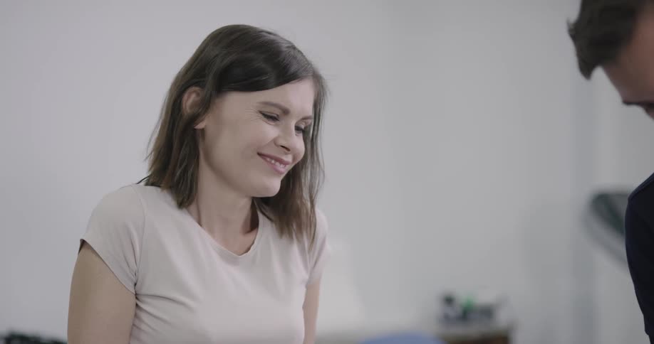 A woman smiles at the doctor