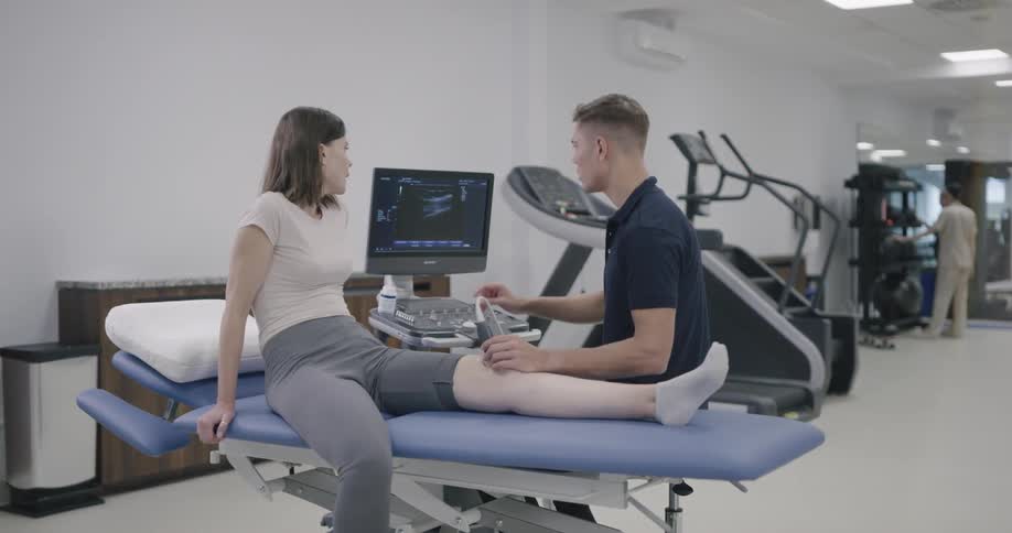 A male therapist checking his female patient leg at the practice room