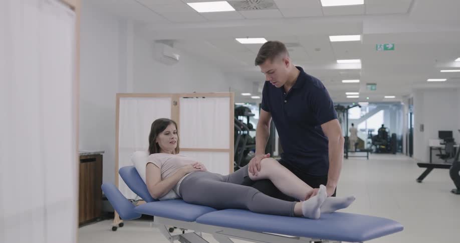 A man works on a womans knee