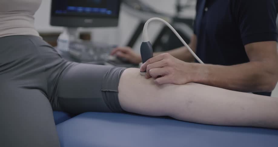 A man is having his knee examined by a sonogram
