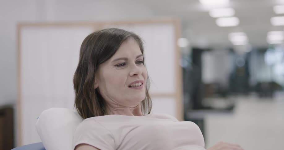 Woman holding pain while her leg is getting massaged