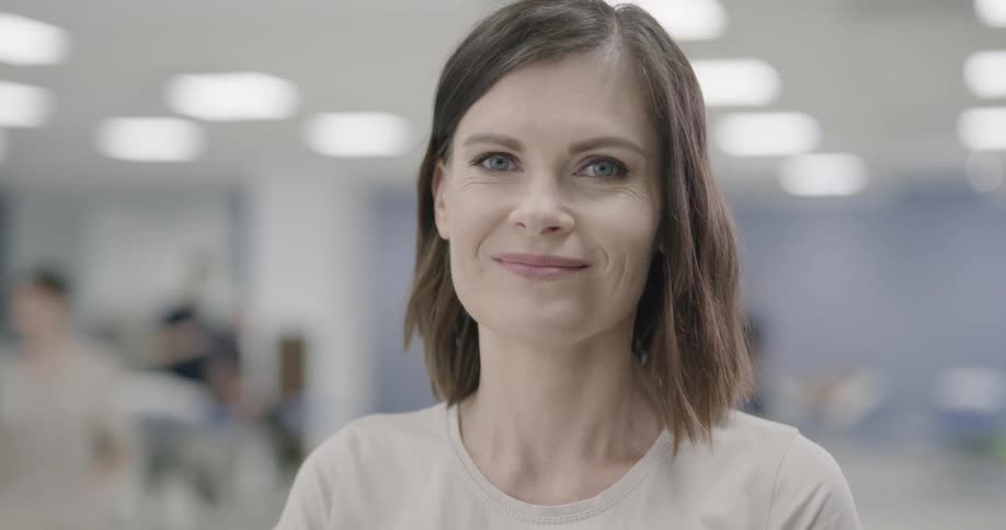 A woman looks ahead and smiles