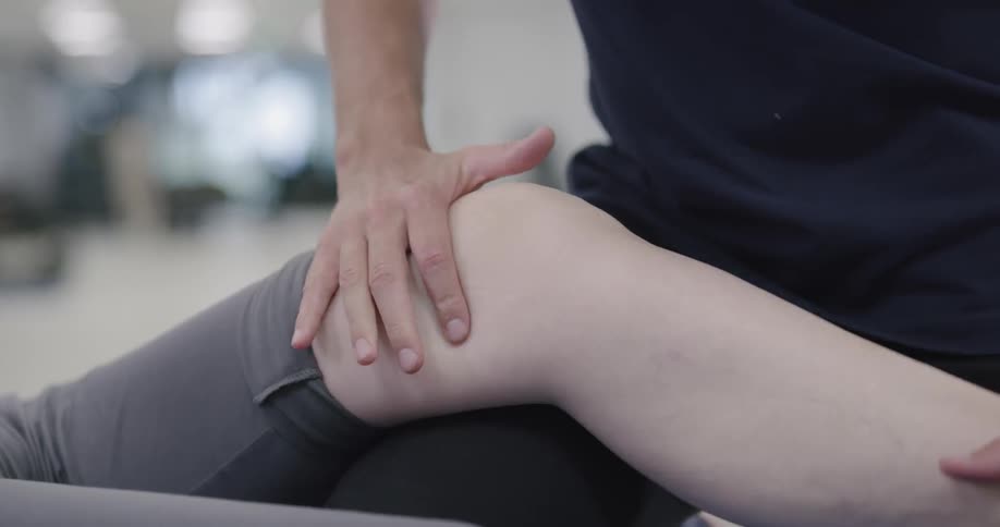 Therapist massaged female patient leg