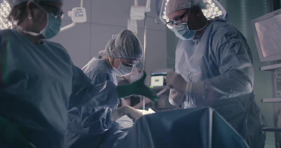 Doctor and nurse doing surgery to a patient