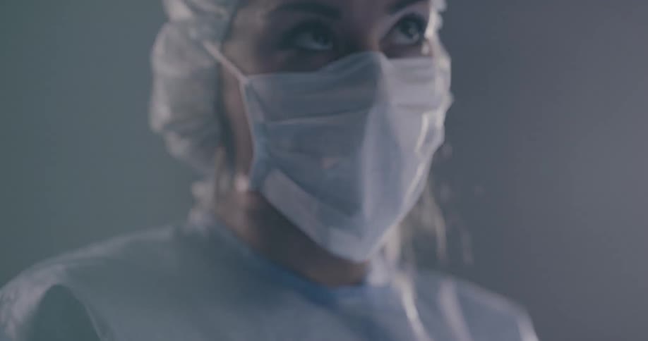 A woman is performing surgery in a room
