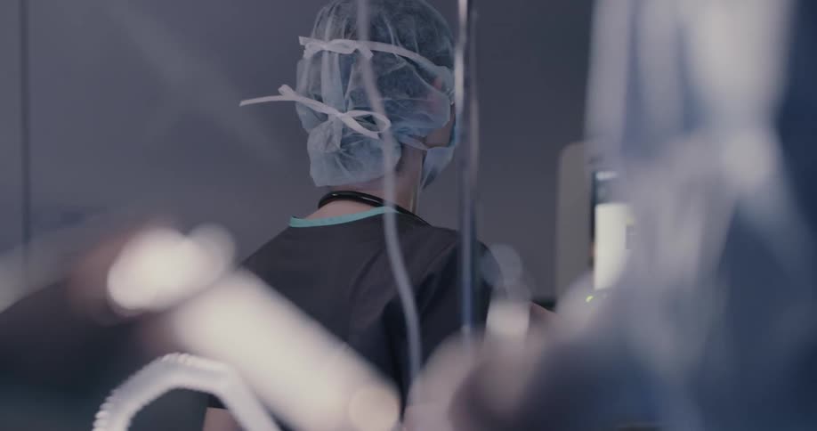 A surgical nurse assisting in a surgery