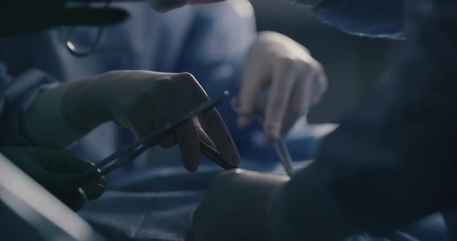 Surgical tools being handed back and forth during a surgery