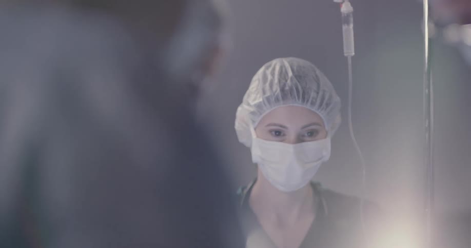 Nurses and a doctor tend to a patient in an operating room