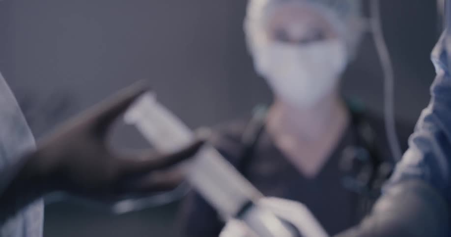 Several people are working on a patient at an operating table